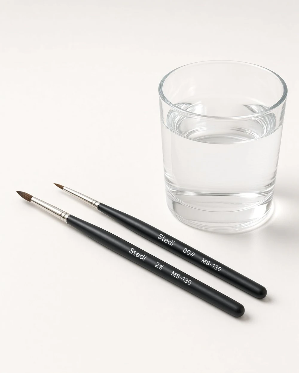 Two brushes: a broad one for coats and a fine one for markings