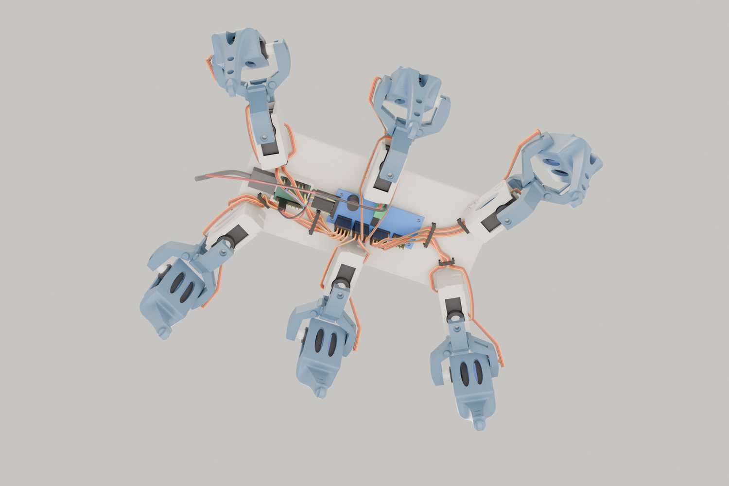 The same robot seen from underneath: a blue servo board and a small green computer under the body plate, with orange servo cables tied along it